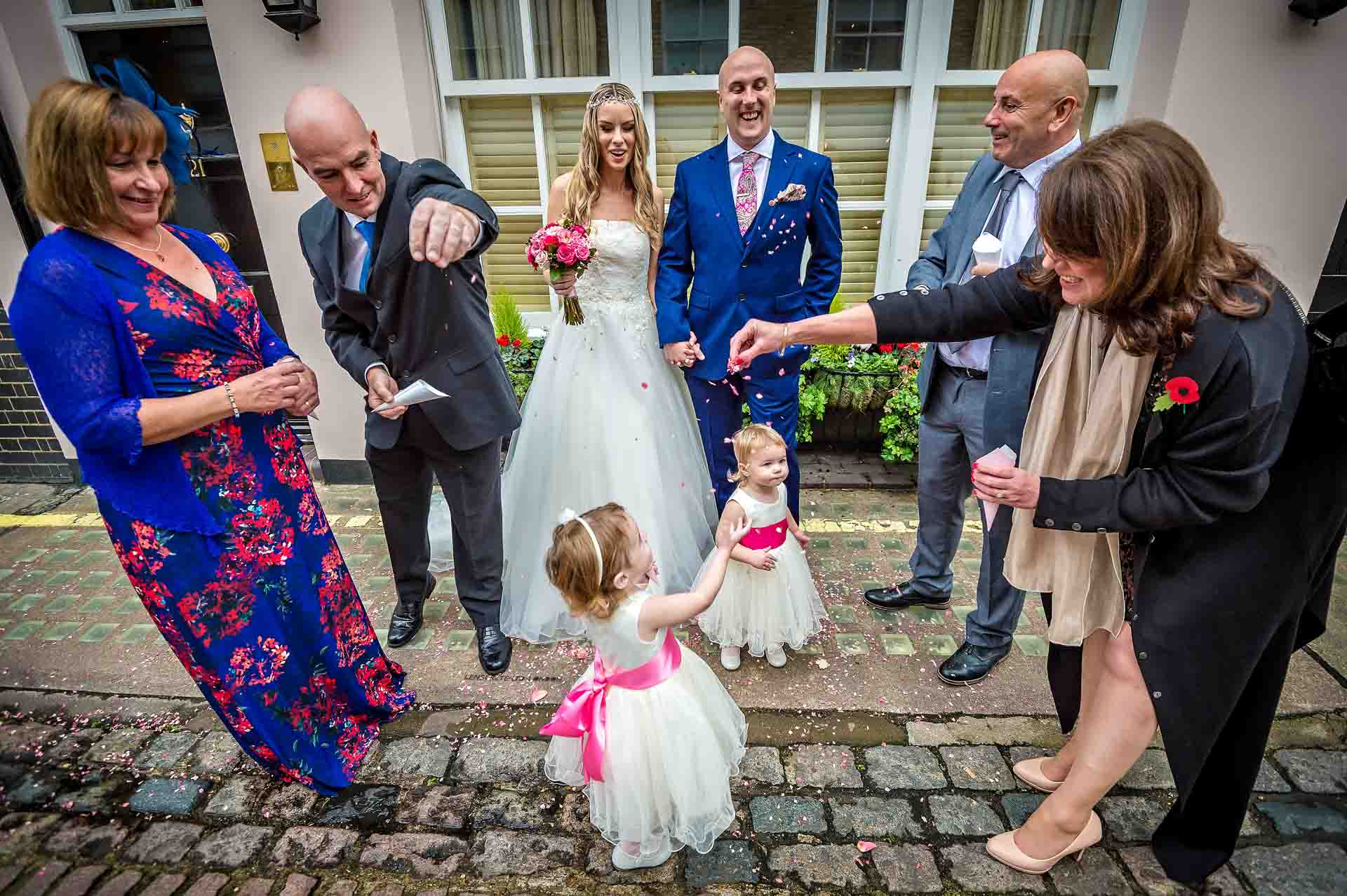 Toddlers in Confetti with Guests at Wedding